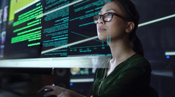 Illustration of young woman working with multiple screens.