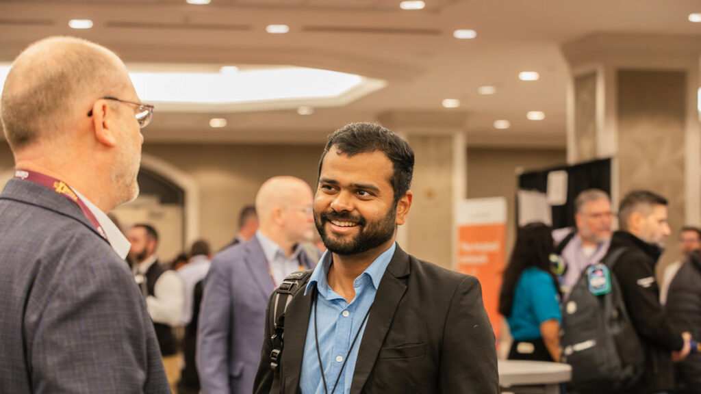 Two professionals conversating during an Internet2 event.