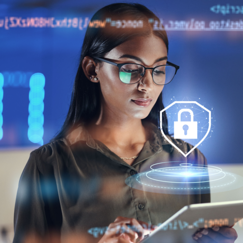 A young woman with long dark hair and glasses looking down at a tablet