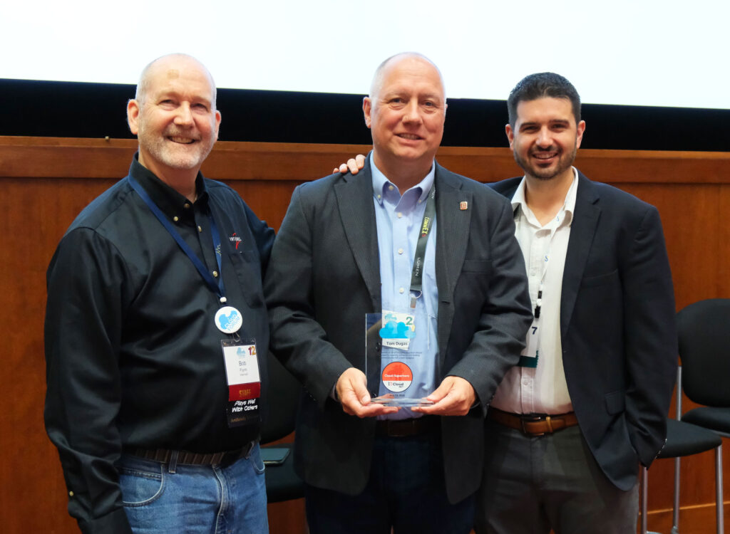 Tom Dugas receiving the cloud superhero award along side Bob Flynn and Sean O'Brien.